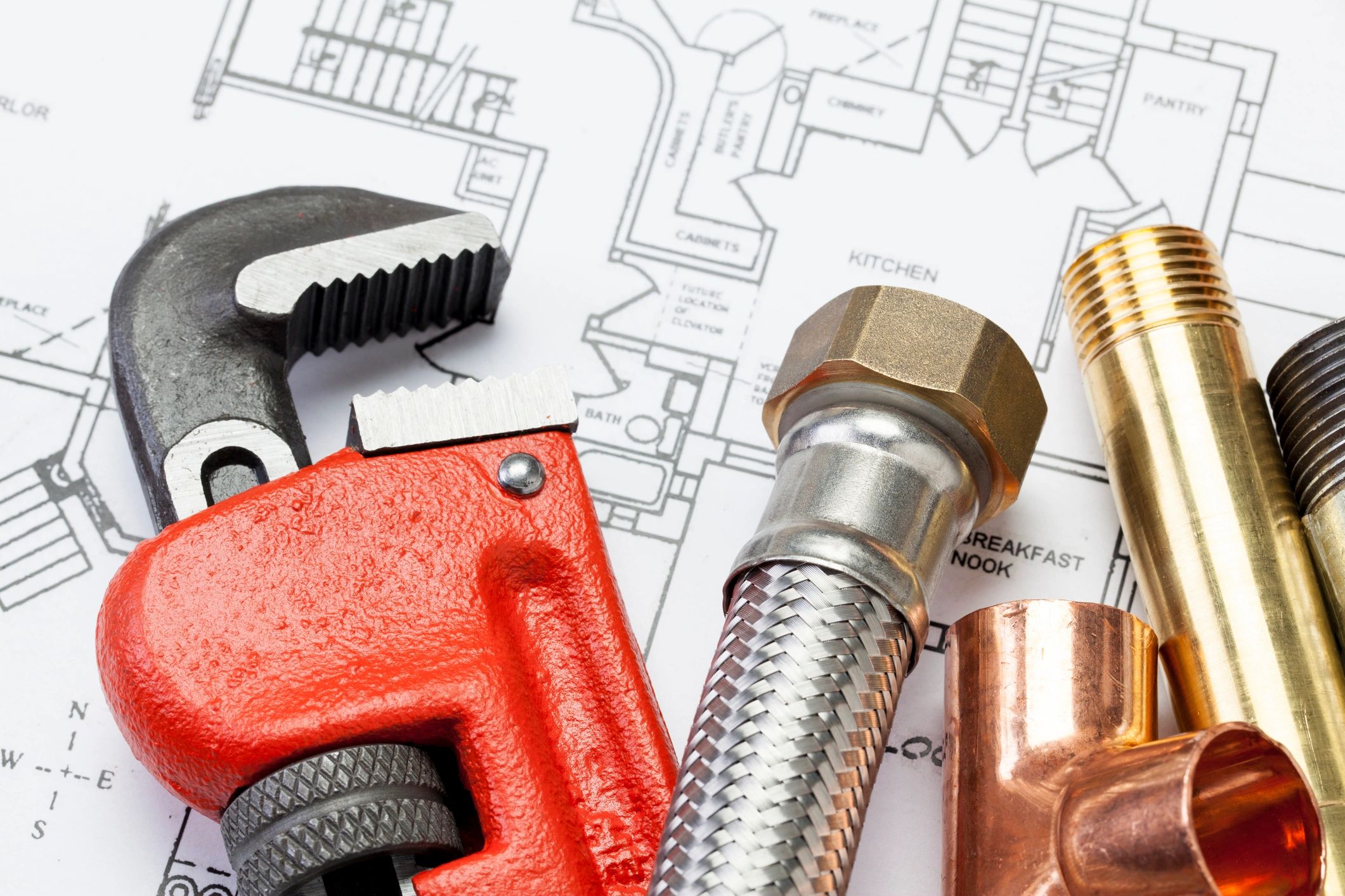 Assorted plumbing tools on a work surface