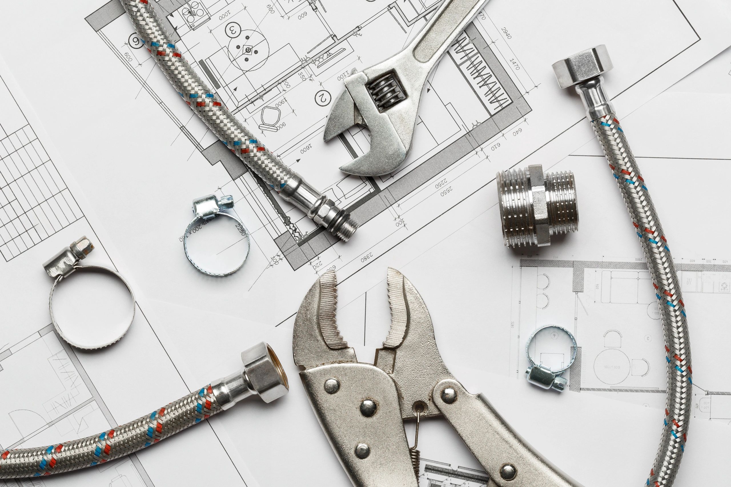 Plumbing tools and fittings laid out for a repair